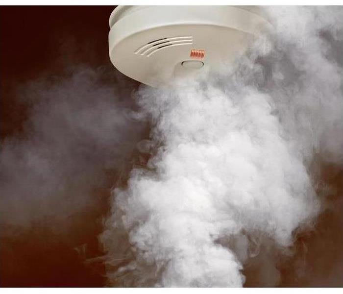 A smoke detector in a smoke filled room.